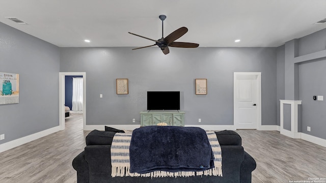 living room with ceiling fan and light hardwood / wood-style floors