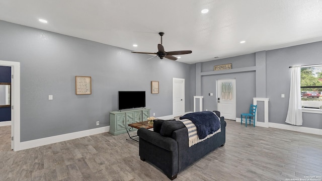 living room with ceiling fan and light hardwood / wood-style floors