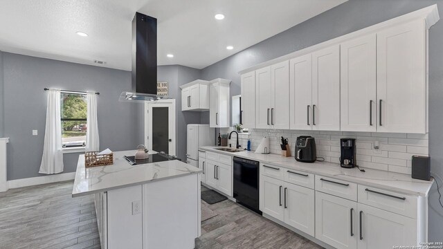 kitchen featuring light stone counters, a kitchen island, ventilation hood, light hardwood / wood-style floors, and black appliances