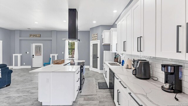 kitchen featuring sink, light wood-type flooring, range with electric cooktop, and island exhaust hood