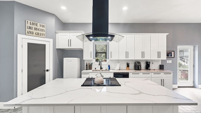 kitchen featuring white cabinetry, a center island, a healthy amount of sunlight, and island exhaust hood