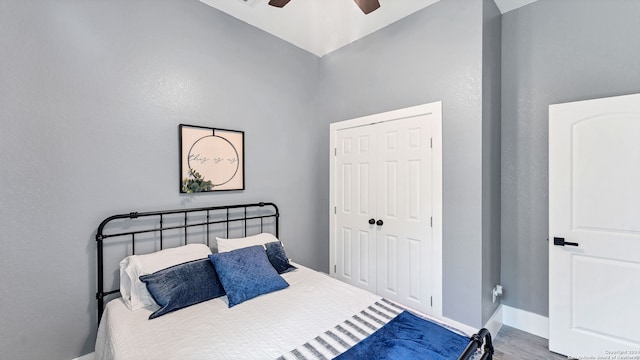 bedroom with a closet, wood-type flooring, and ceiling fan