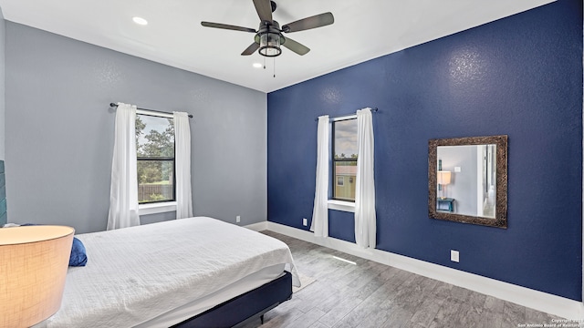 bedroom featuring hardwood / wood-style flooring and ceiling fan