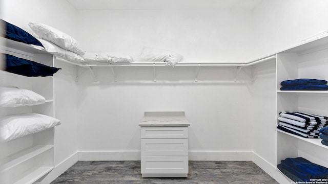 walk in closet featuring dark wood-type flooring