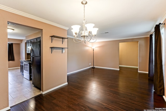 spare room with ornamental molding, an inviting chandelier, and dark wood-type flooring