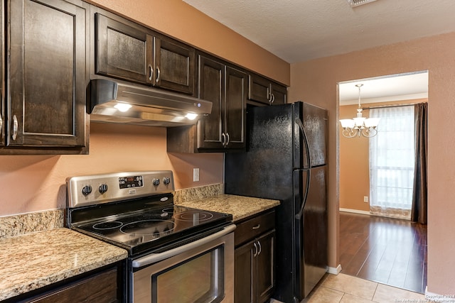 kitchen featuring electric range, light hardwood / wood-style flooring, a chandelier, hanging light fixtures, and dark brown cabinetry