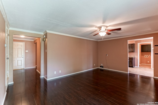 empty room with ornamental molding, a textured ceiling, hardwood / wood-style flooring, and ceiling fan