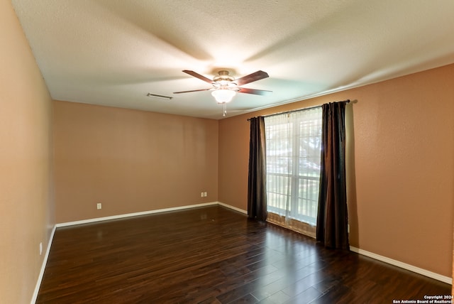 unfurnished room with a textured ceiling, ceiling fan, and dark hardwood / wood-style floors