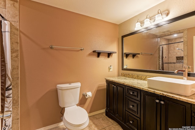 bathroom with toilet, tile patterned flooring, and double sink vanity