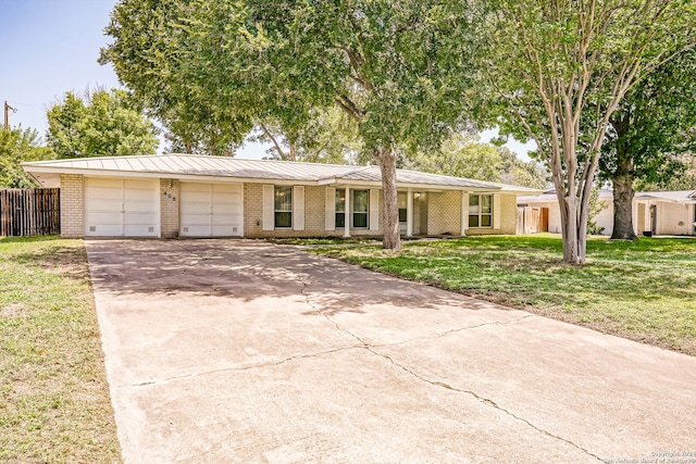 single story home with a garage and a front lawn