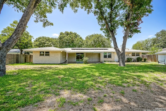 rear view of house with a yard