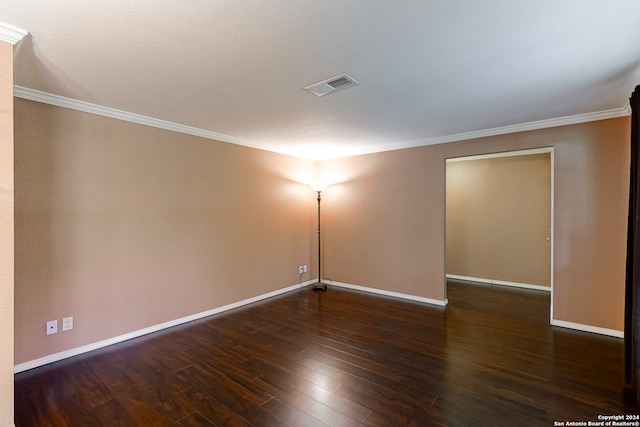 empty room with dark wood-type flooring and ornamental molding