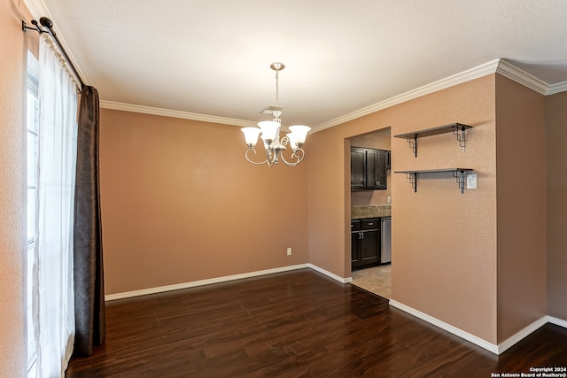 unfurnished living room featuring dark wood-type flooring, ornamental molding, and a notable chandelier