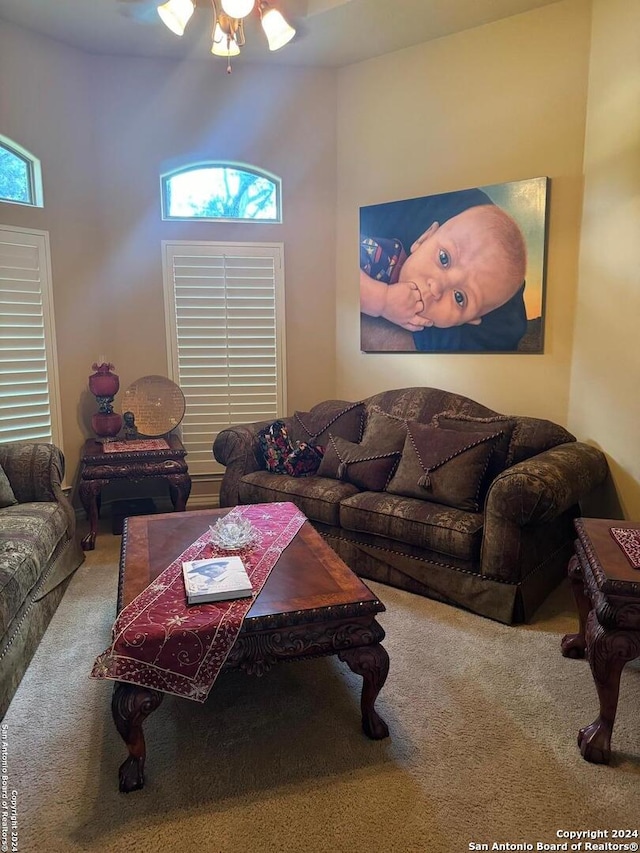 carpeted living room with a wealth of natural light and ceiling fan