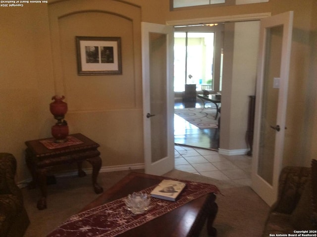 corridor with french doors and light tile patterned floors