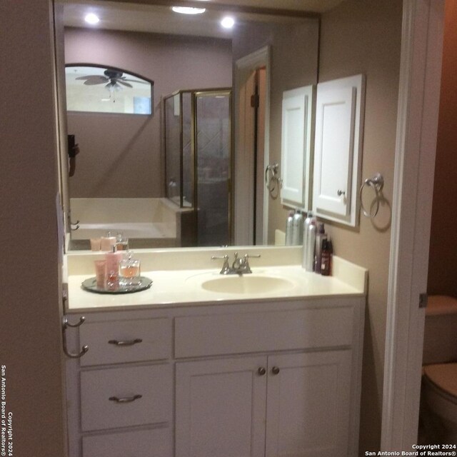 bathroom featuring vanity, ceiling fan, and toilet