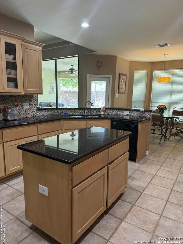 kitchen with pendant lighting, light tile patterned floors, sink, and a kitchen island