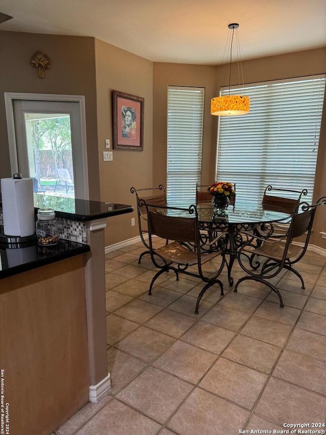 dining space featuring light tile patterned floors