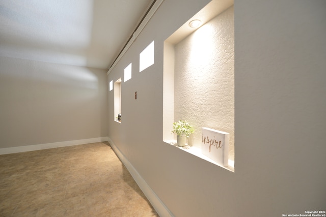 hallway with light colored carpet