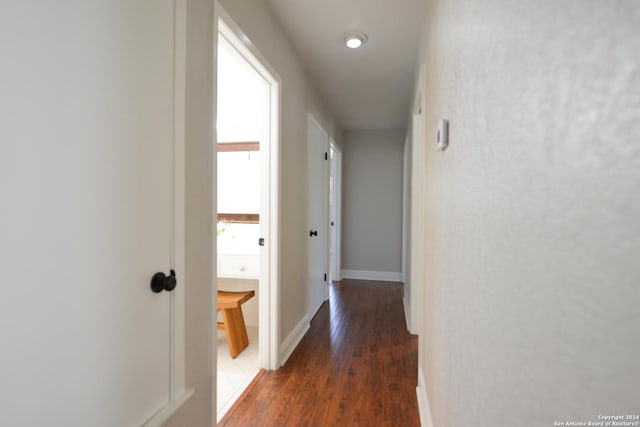 hallway with dark hardwood / wood-style floors