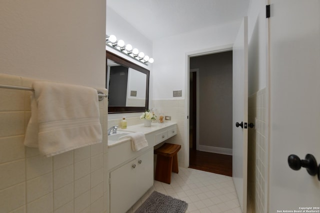 bathroom featuring tile walls and vanity