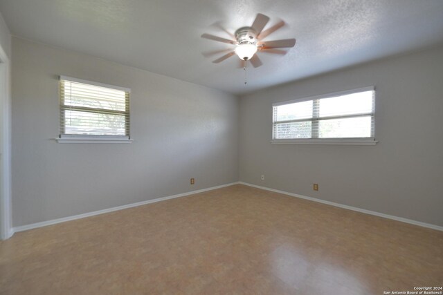 unfurnished bedroom with a textured ceiling, a closet, and ceiling fan