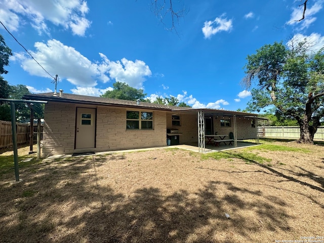 rear view of property featuring a patio area