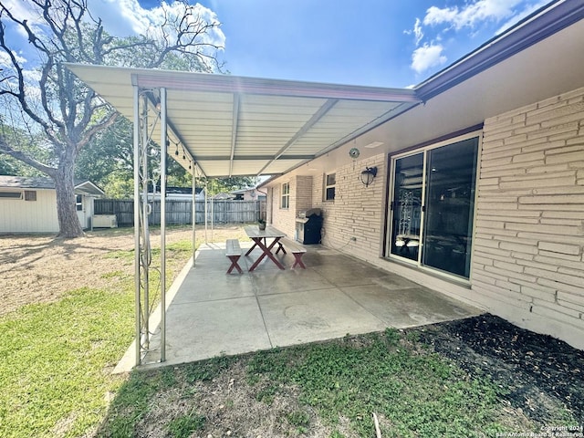 view of patio / terrace with a grill and a storage shed