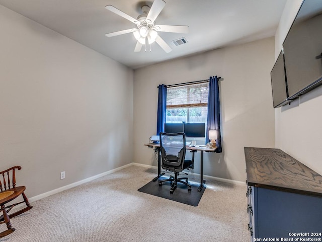 office space featuring light carpet, baseboards, visible vents, and ceiling fan