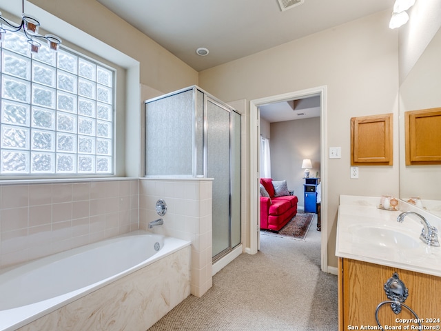 bathroom with vanity and separate shower and tub