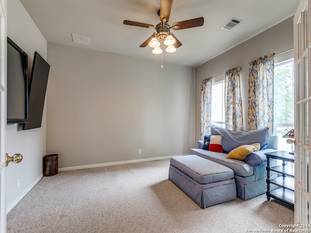 living area with ceiling fan and light colored carpet