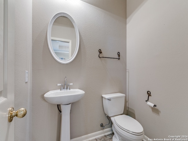 bathroom featuring toilet and tile patterned floors