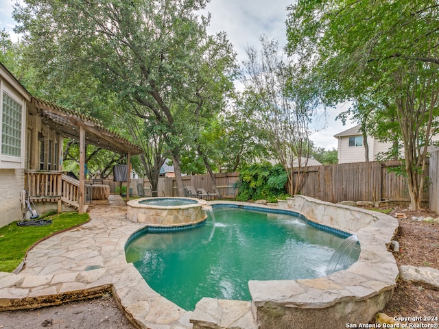 view of swimming pool with pool water feature, an in ground hot tub, and a pergola