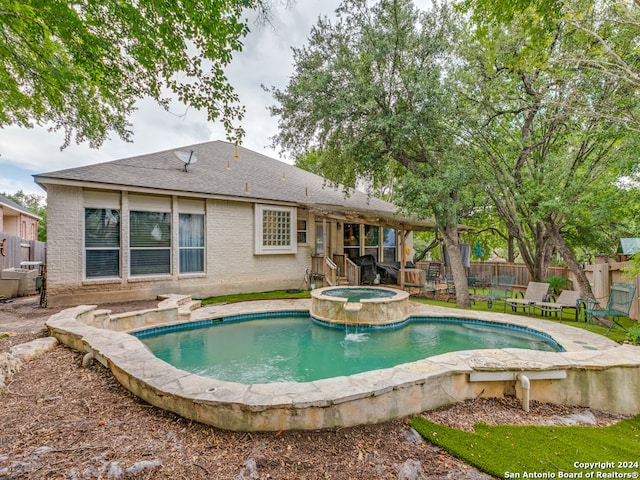 view of pool with an in ground hot tub