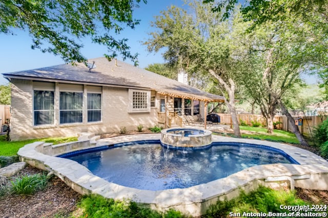 view of swimming pool featuring an in ground hot tub