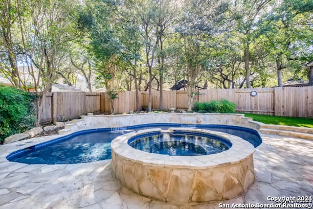 view of pool featuring an in ground hot tub, a patio area, a fenced backyard, and a fenced in pool