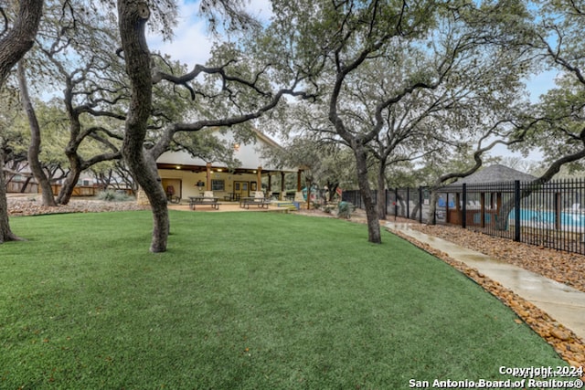 view of yard featuring a community pool and a patio area