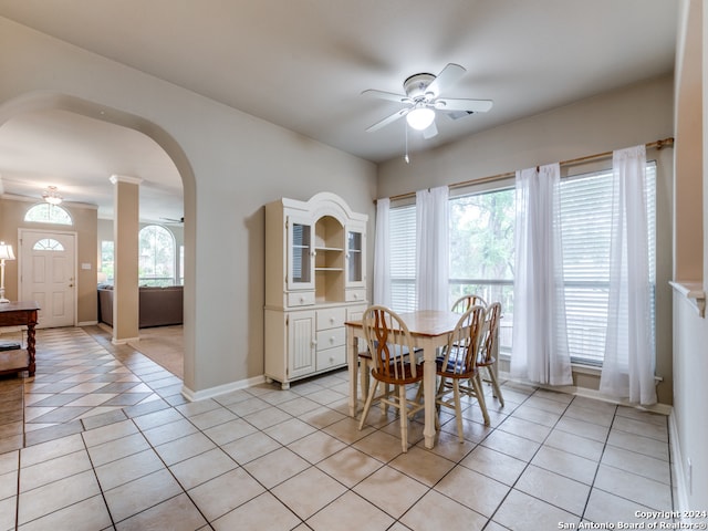 dining space with a wealth of natural light, ceiling fan, and light tile patterned floors