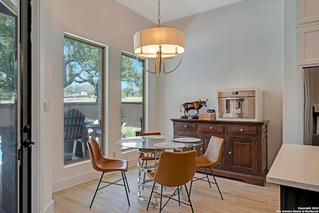 dining room featuring light hardwood / wood-style floors and a chandelier