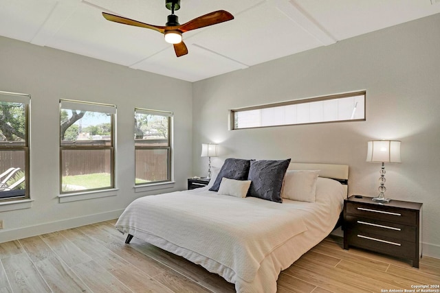 bedroom with ceiling fan and light hardwood / wood-style flooring