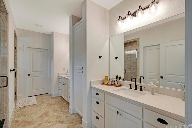 bathroom with vanity, a shower with door, and tile patterned flooring