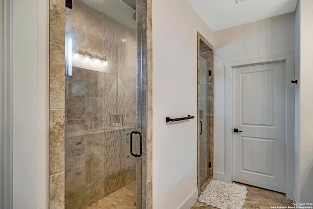 bathroom with a shower with shower door