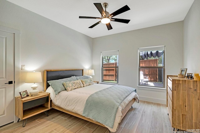 bedroom with light hardwood / wood-style floors and ceiling fan