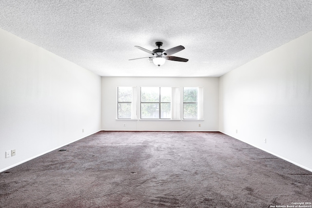 carpeted empty room featuring a textured ceiling and ceiling fan