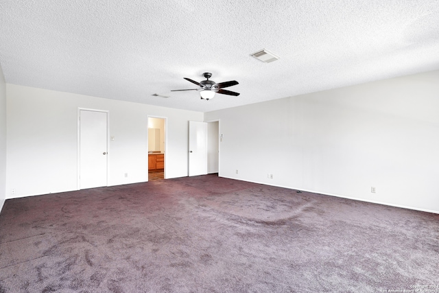 carpeted spare room featuring a textured ceiling and ceiling fan