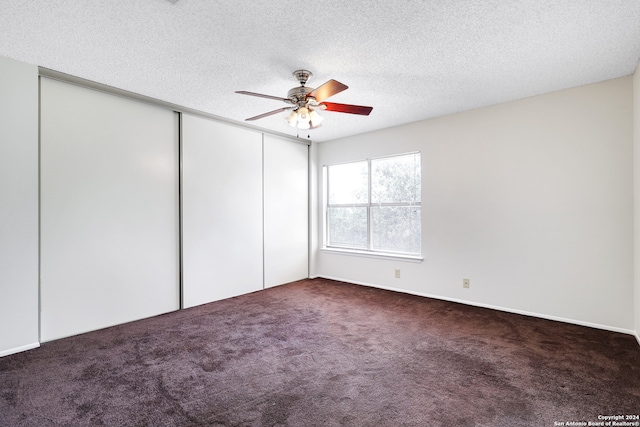 unfurnished bedroom with a textured ceiling, carpet floors, and ceiling fan