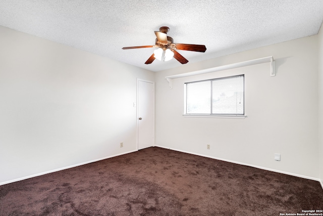 spare room featuring a textured ceiling, ceiling fan, and carpet flooring