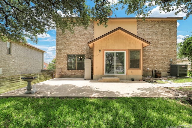 back of house featuring a patio area, cooling unit, and a yard