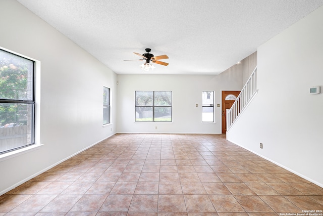 empty room with a wealth of natural light and light tile patterned floors