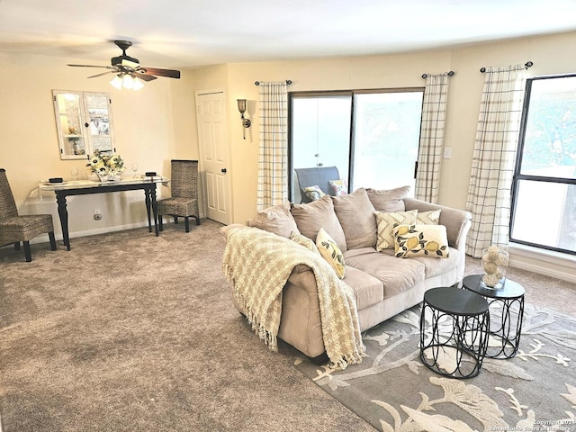 living area featuring carpet flooring, ceiling fan, and baseboards